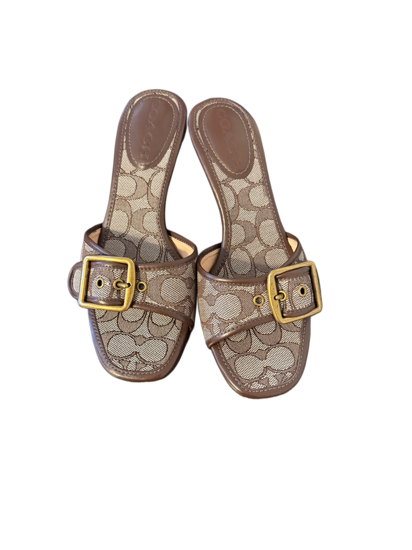 Buckled straps and kitten heels elevate a dressy look in the signature texture and trim on the pretty Margot sandals by COACH.